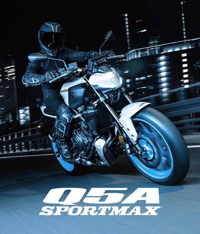Image of rider on a motorcycle on the urban road